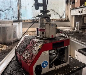 Laboratory equipment coated in soot and chemical residue